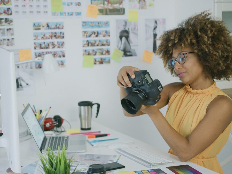 Stylish photographer at creative workplace